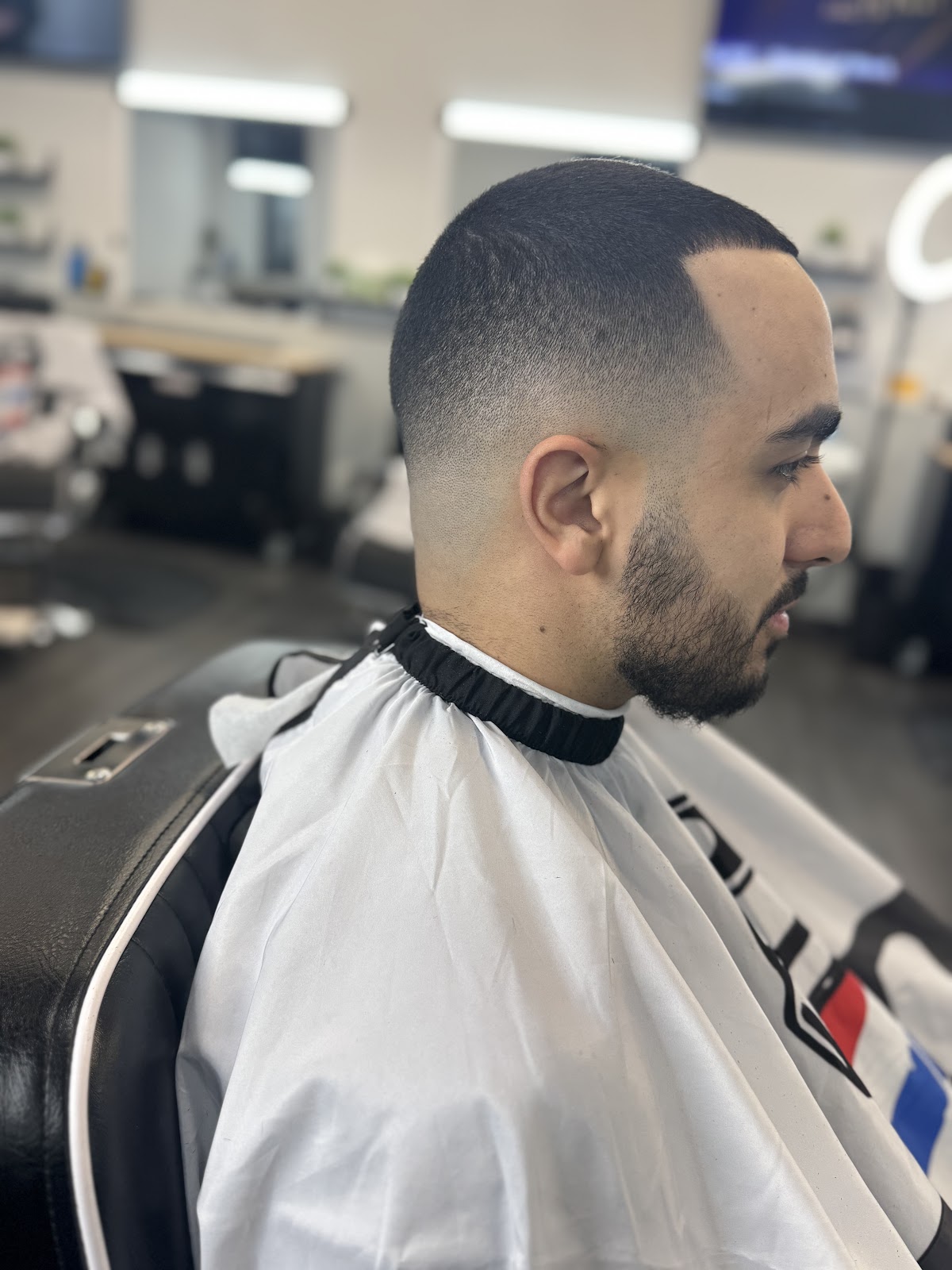 Sharp high skin fade profile shot in shop