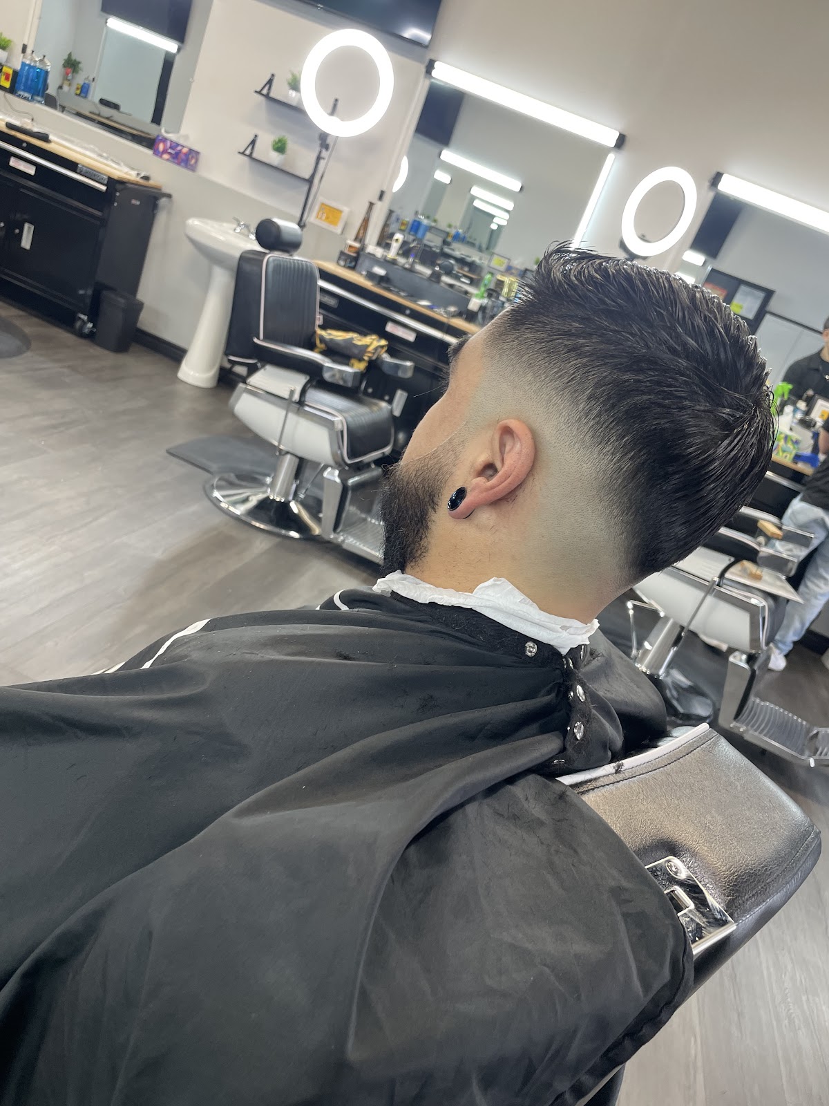Slick back taper fade rear view with shop chairs