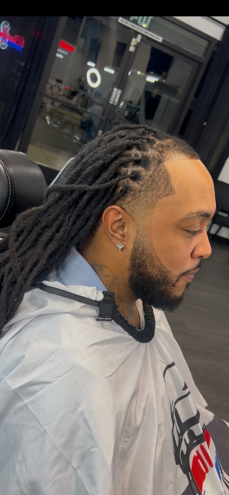 Man with long locs and faded sides in shop